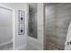 Spa-like shower with beige tile and a frameless glass door at 124 Everley Walk, Alpharetta, GA 30009