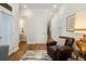 Bright sitting room with hardwood floors, a leather chair, and access to a half-bathroom at 124 Everley Walk, Alpharetta, GA 30009