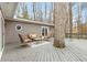 Outdoor deck with cozy seating area and a large tree integrated into the design at 3374 Timber Lake Nw Rd, Kennesaw, GA 30144