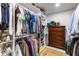 Well-organized walk-in closet with shelving, hanging racks, and a wooden dresser at 3374 Timber Lake Nw Rd, Kennesaw, GA 30144