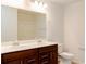 Bathroom with double vanity, large mirror, and shower/tub combo at 5482 Fountainhead Ln, Auburn, GA 30011