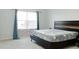 Bright bedroom with carpeted floors and large window at 5482 Fountainhead Ln, Auburn, GA 30011