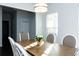 Sunlit dining area with a wood table and gray chairs at 5482 Fountainhead Ln, Auburn, GA 30011