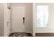 Simple entryway with white door and geometric rug at 5482 Fountainhead Ln, Auburn, GA 30011