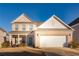 Two-story brick home with a large white garage door and landscaping at 5482 Fountainhead Ln, Auburn, GA 30011