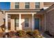 Quaint front porch with teal door and white columns at 5482 Fountainhead Ln, Auburn, GA 30011