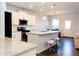 Modern kitchen with white cabinets, granite counters and island at 5482 Fountainhead Ln, Auburn, GA 30011