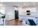 Open concept kitchen with island and hardwood floors at 5482 Fountainhead Ln, Auburn, GA 30011