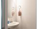 Small half bathroom with white sink and oval mirror at 5482 Fountainhead Ln, Auburn, GA 30011