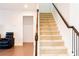 Modern staircase with carpeted steps and wooden handrail at 5482 Fountainhead Ln, Auburn, GA 30011
