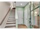 Modern staircase with wood steps and a light green wall at 723 Perch Pl, Atlanta, GA 30312