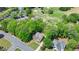 Aerial view of a brick home with green lawn, neighboring a golf course, showcasing community and recreational opportunity at 5915 Masters Club Dr, Suwanee, GA 30024