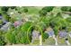 Aerial view highlighting the property's location near a golf course and other houses in a lush, green neighborhood at 5915 Masters Club Dr, Suwanee, GA 30024