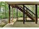 An outdoor staircase leads to the wooden deck with a forest view at 5915 Masters Club Dr, Suwanee, GA 30024