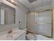 A functional bathroom offers a single sink vanity and a shower tub with sliding doors at 5915 Masters Club Dr, Suwanee, GA 30024