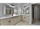 Bathroom featuring double vanities, granite countertops, modern lighting, and access to a walk-in closet at 5915 Masters Club Dr, Suwanee, GA 30024