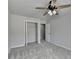 Bedroom featuring neutral walls, plush carpeting, a ceiling fan, closet, and natural light at 5915 Masters Club Dr, Suwanee, GA 30024