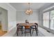 Dining room featuring modern chandelier, carpet, and wainscoting at 5915 Masters Club Dr, Suwanee, GA 30024