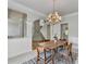 Dining room with chandelier, and open access to the staircase at 5915 Masters Club Dr, Suwanee, GA 30024
