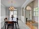 Formal dining room with chandelier, natural light, and modern design at 5915 Masters Club Dr, Suwanee, GA 30024