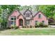 Charming two-story brick home with manicured lawn and mature trees, offering great curb appeal in a desirable neighborhood at 5915 Masters Club Dr, Suwanee, GA 30024