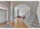 Inviting foyer featuring hardwood floors, staircase, and an arched doorway at 5915 Masters Club Dr, Suwanee, GA 30024