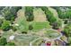 Elevated view of a well-maintained golf course featuring manicured greens, sand traps, and scenic cart paths at 5915 Masters Club Dr, Suwanee, GA 30024