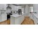 Stylish kitchen with white cabinetry, stainless steel appliances, and a view of the adjacent dining area at 5915 Masters Club Dr, Suwanee, GA 30024