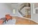 Bright living room features hardwood floors, large windows, and an open staircase at 5915 Masters Club Dr, Suwanee, GA 30024