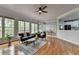 Bright living area with large windows, hardwood floors, and a view to the dining area and kitchen at 5915 Masters Club Dr, Suwanee, GA 30024