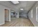A spacious living room has wood-look flooring and is freshly painted in a neutral color at 5915 Masters Club Dr, Suwanee, GA 30024