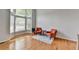 Bright living room featuring hardwood floors, a bay window, and two accent chairs at 5915 Masters Club Dr, Suwanee, GA 30024
