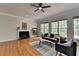 Cozy living room with fireplace, hardwood floors, and an abundance of natural light at 5915 Masters Club Dr, Suwanee, GA 30024