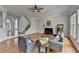 Spacious living room with hardwood floors, fireplace, and staircase access, filled with natural light at 5915 Masters Club Dr, Suwanee, GA 30024