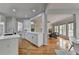 Open concept design showcasing a kitchen overlooking the living room with a fireplace and large windows at 5915 Masters Club Dr, Suwanee, GA 30024