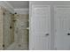 Shower featuring frameless glass door and light beige and tan tiled surround at 5915 Masters Club Dr, Suwanee, GA 30024