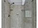 Shower featuring frameless glass door, beige tile surround with design accents, built-in shelves, and a shower head at 5915 Masters Club Dr, Suwanee, GA 30024