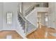 Elegant staircase with carpeted steps and wrought iron railings at 5915 Masters Club Dr, Suwanee, GA 30024