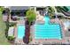 Aerial view of a community pool area featuring multiple pools, including a lap pool and leisure pools, surrounded by patios at 5915 Masters Club Dr, Suwanee, GA 30024