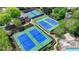 Overhead shot of the tennis complex, featuring well-maintained courts and surrounding manicured landscaping at 5915 Masters Club Dr, Suwanee, GA 30024
