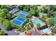 Aerial view of a community tennis and sports complex, including tennis courts, swimming pools, and garden at 5915 Masters Club Dr, Suwanee, GA 30024