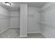 Walk-in closet featuring wire shelving, gray walls, and carpeted flooring at 5915 Masters Club Dr, Suwanee, GA 30024
