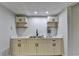 A contemporary wet bar features shaker cabinets, open shelves, and a modern subway tile backsplash at 5915 Masters Club Dr, Suwanee, GA 30024