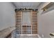 A modern wine cellar shows a wine rack with a granite countertop and overhead lighting at 5915 Masters Club Dr, Suwanee, GA 30024