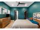 Stylish bedroom with dark turquoise walls, a ceiling fan, a bed, and a dresser at 611 King Arnold St, Atlanta, GA 30354