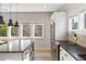 Bright kitchen featuring stainless steel appliances, island with cooktop, and natural light from several windows at 611 King Arnold St, Hapeville, GA 30354