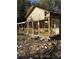 A rustic house undergoing renovation, revealing its wooden frame and porch at 1386 Highway 92 S, Fayetteville, GA 30215