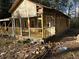 A dilapidated house under renovation, showing its wooden frame and porch at 1386 Highway 92 S, Fayetteville, GA 30215