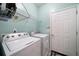 Convenient laundry room with washer, dryer, and overhead storage at 3208 Abbott Dr # 12, Powder Springs, GA 30127