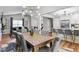 Dining area with large wooden table and modern light fixture at 8316 Glenwoods Dr, Riverdale, GA 30274